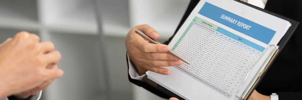 Person explaining written report to his colleague. 